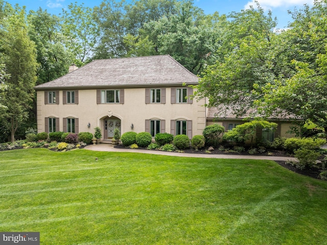130 Hunt Valley Cir, Berwyn, PA 19312 - colonial inspired home with a front yard, a chimney, and french doors