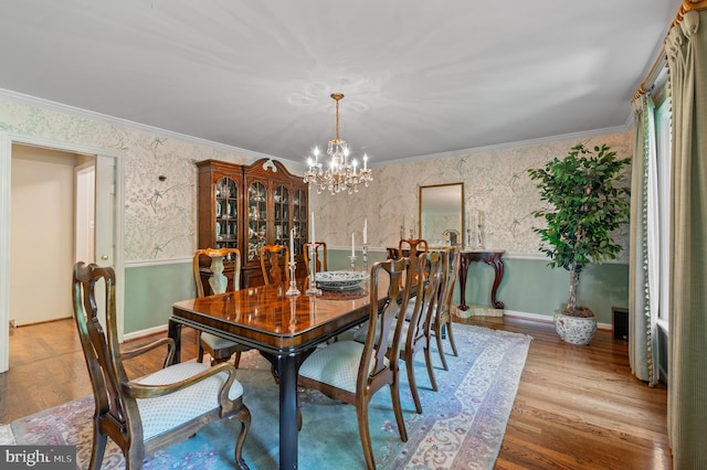 130 Hunt Valley Cir, Berwyn, PA 19312 - dining room featuring a chandelier, wood finished floors, ornamental molding, and wallpapered walls