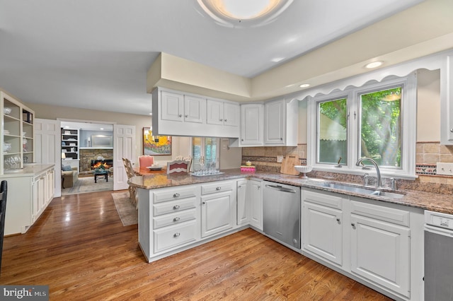130 Hunt Valley Cir, Berwyn, PA 19312 - kitchen with stainless steel dishwasher, healthy amount of natural light, white cabinetry, and tasteful backsplash