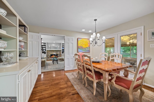 130 Hunt Valley Cir, Berwyn, PA 19312 - dining space featuring wood finished floors, a stone fireplace, recessed lighting, and a chandelier