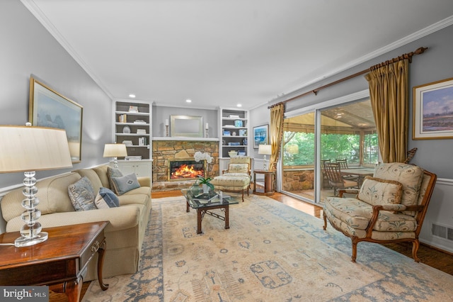 130 Hunt Valley Cir, Berwyn, PA 19312 - living room with crown molding, wood finished floors, a stone fireplace, built in shelves, and recessed lighting