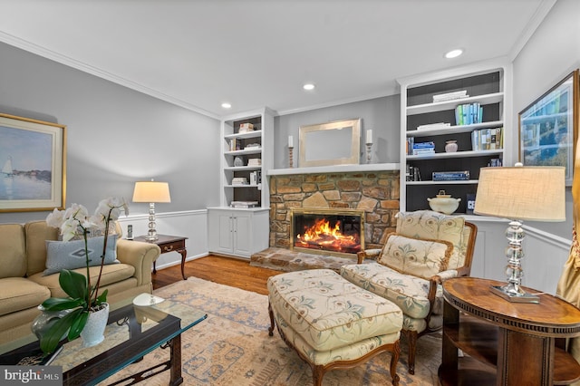 130 Hunt Valley Cir, Berwyn, PA 19312 - living room featuring ornamental molding, built in shelves, a fireplace, wood finished floors, and recessed lighting