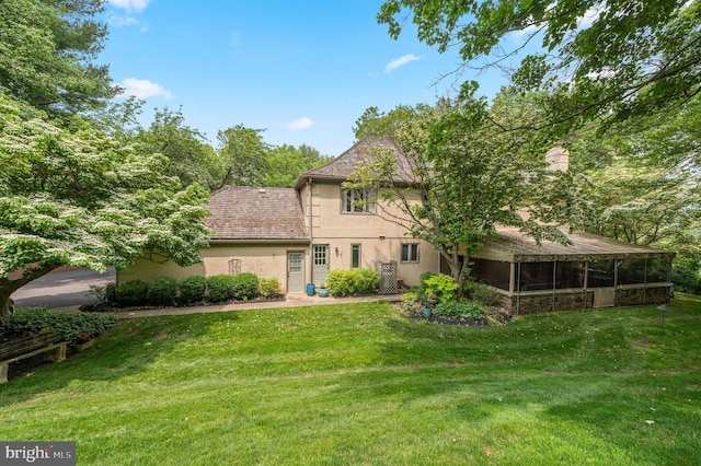 130 Hunt Valley Cir, Berwyn, PA 19312 - view of front facade with stucco siding, a sunroom, and a front yard