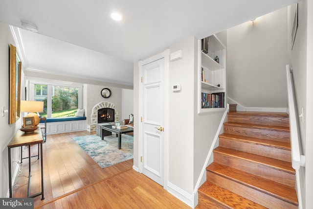 112 Oxley Ct, Newtown Square, PA 19073 - stairway with wood finished floors and a stone fireplace