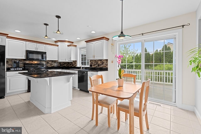 501 Bald Eagle Ct, Lancaster, PA 17601 - kitchen with black appliances, dark countertops, decorative backsplash, a kitchen island, and recessed lighting