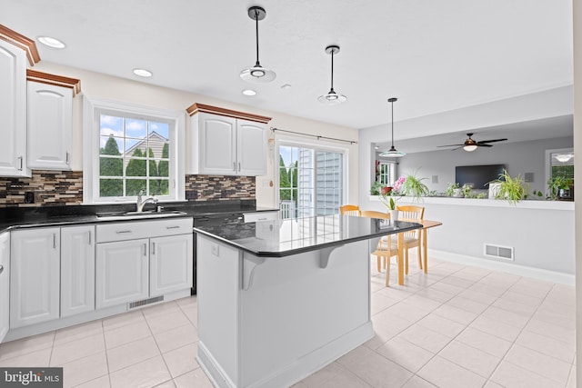 501 Bald Eagle Ct, Lancaster, PA 17601 - kitchen featuring light tile patterned floors, hanging light fixtures, tasteful backsplash, plenty of natural light, and recessed lighting