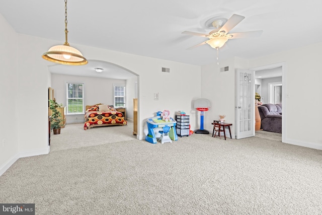 501 Bald Eagle Ct, Lancaster, PA 17601 - recreation room featuring carpet floors, arched walkways, ceiling fan, and french doors