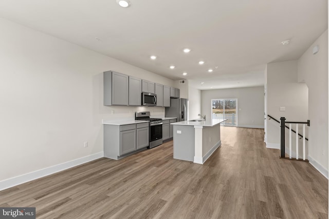 10624 Meridian Hill Way, Upper Marlboro, MD 20772 - kitchen with stainless steel appliances, gray cabinets, recessed lighting, light countertops, and light wood-style flooring