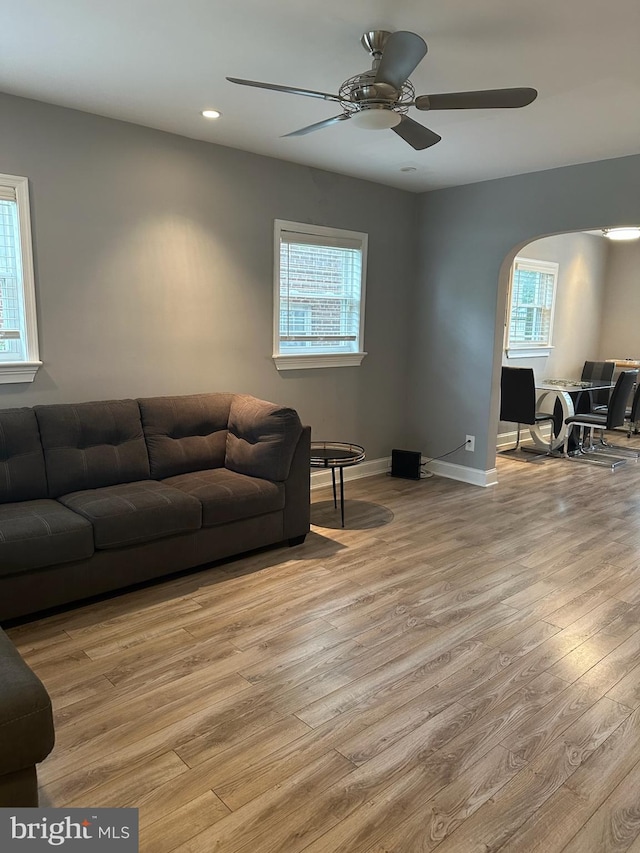 4627 12th St NE, Washington, DC 20017 - living area featuring healthy amount of natural light, wood finished floors, arched walkways, a ceiling fan, and recessed lighting