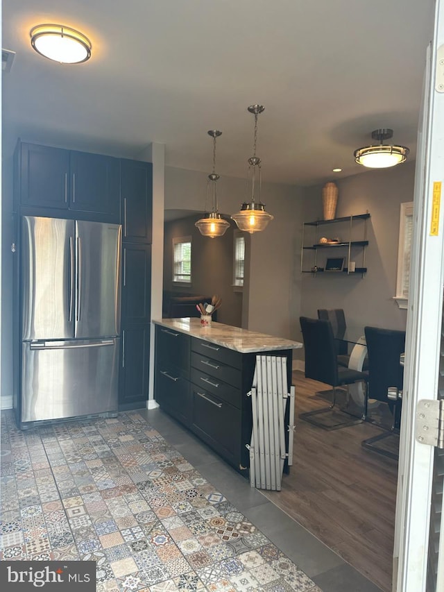 4627 12th St NE, Washington, DC 20017 - kitchen with freestanding refrigerator, blue cabinetry, pendant lighting, light stone counters, and a peninsula