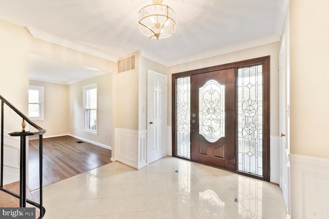 1517 Tuba Ct, Vienna, VA 22182 - foyer with a chandelier, crown molding, a wainscoted wall, and stairway