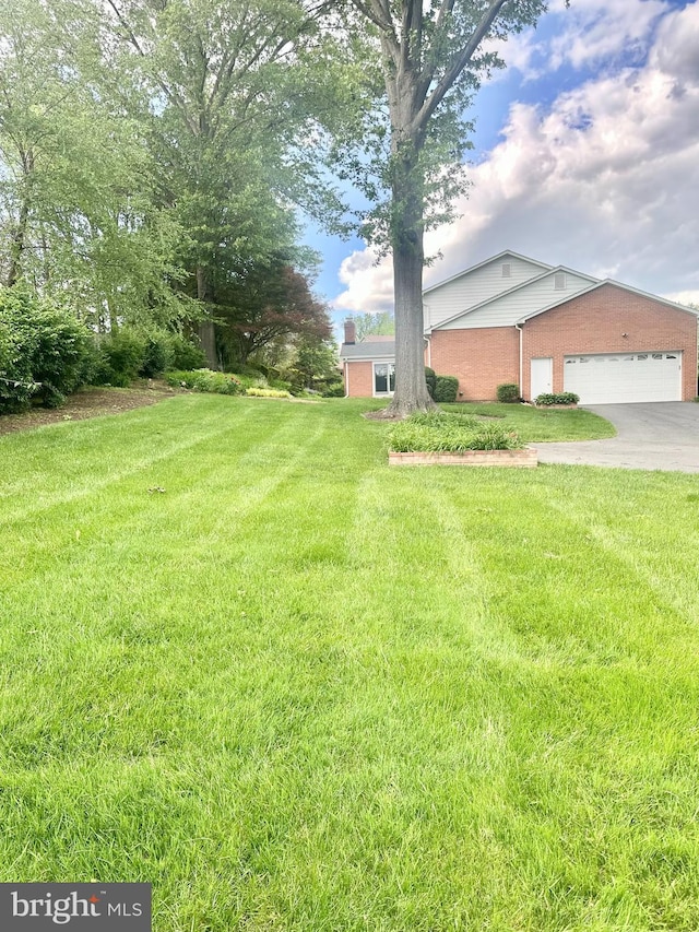 1517 Tuba Ct, Vienna, VA 22182 - view of grassy yard featuring driveway and an attached garage