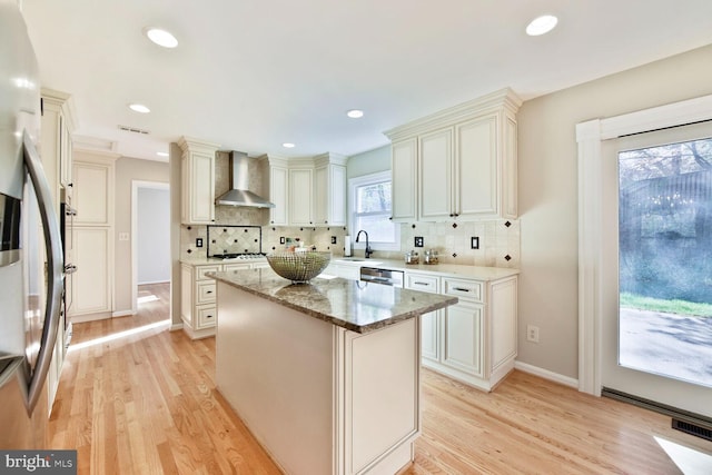 1517 Tuba Ct, Vienna, VA 22182 - kitchen featuring wall chimney range hood, light wood finished floors, light stone countertops, decorative backsplash, and recessed lighting