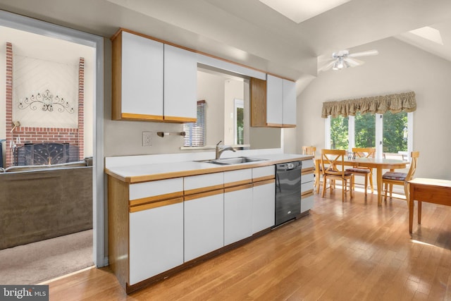 24 Rosette Ln, Richboro, PA 18954 - kitchen with black dishwasher, light countertops, white cabinets, light wood-style flooring, and vaulted ceiling