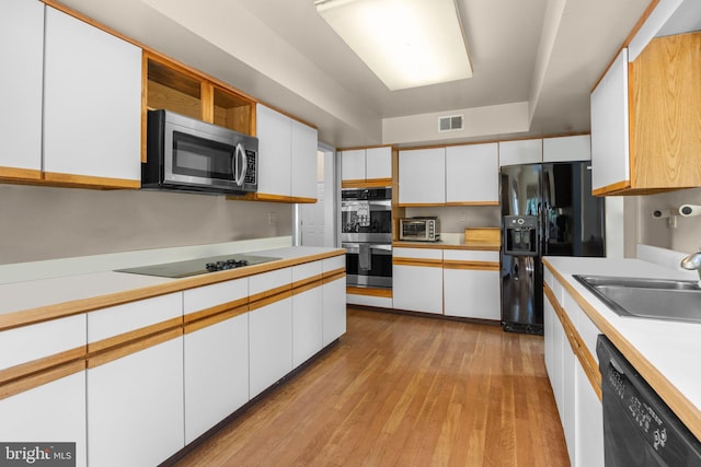 24 Rosette Ln, Richboro, PA 18954 - kitchen with black appliances, light countertops, white cabinetry, light wood-style floors, and open shelves