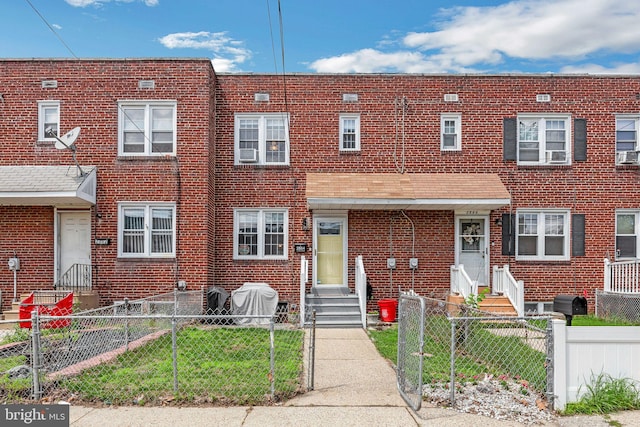 2864 Cushing Rd, Camden, NJ 08104 - townhome / multi-family property with entry steps, brick siding, and a fenced front yard