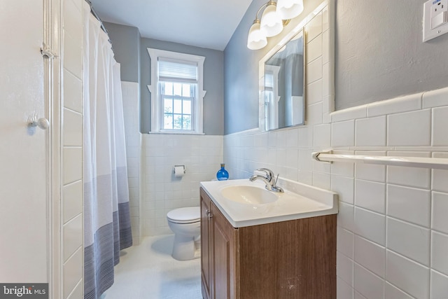 2864 Cushing Rd, Camden, NJ 08104 - bathroom with vanity, tile walls, curtained shower, and a wainscoted wall