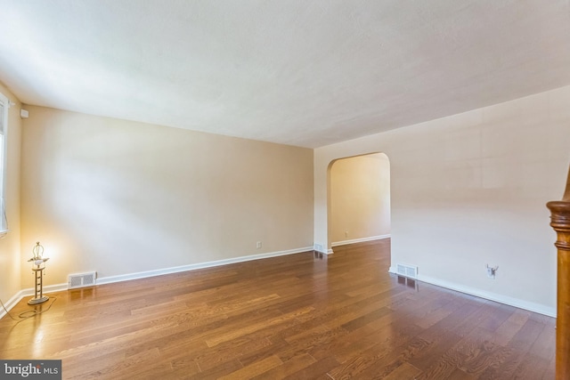 2864 Cushing Rd, Camden, NJ 08104 - unfurnished room with arched walkways and dark wood-style floors