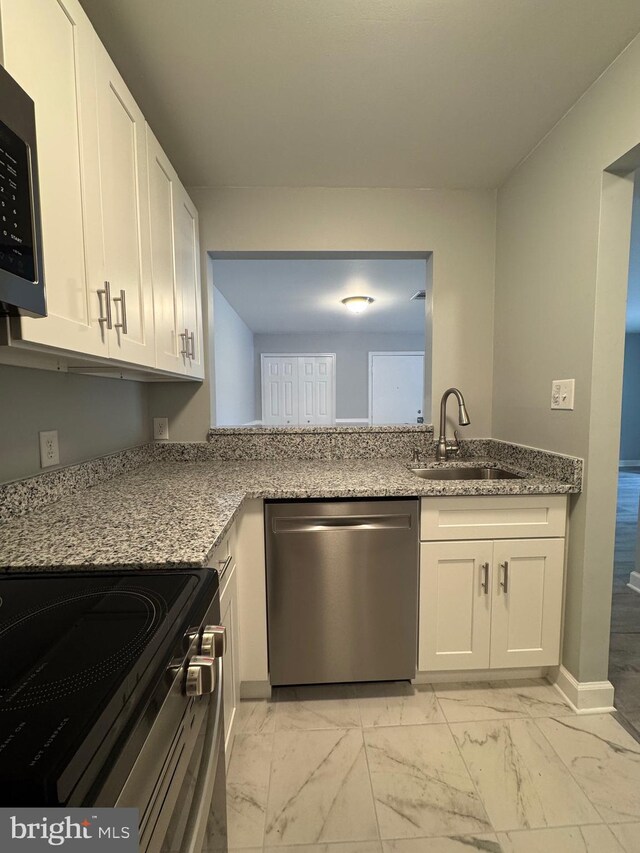 202 Grosvenor Lane 72 ( Apt. 3), Stafford, VA 22556 - kitchen featuring stainless steel appliances, light marble finish flooring, and white cabinetry