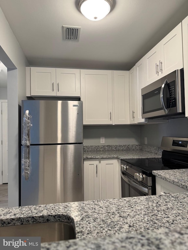 202 Grosvenor Lane 72 ( Apt. 3), Stafford, VA 22556 - kitchen with stainless steel appliances, white cabinets, and light stone counters