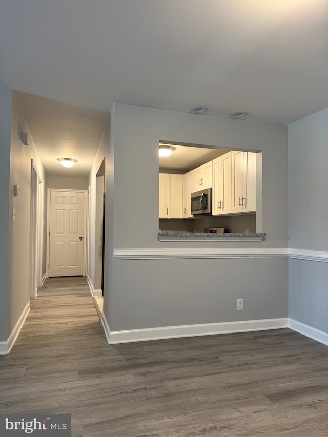 202 Grosvenor Lane 72 ( Apt. 3), Stafford, VA 22556 - kitchen featuring stainless steel microwave, white cabinetry, and wood finished floors