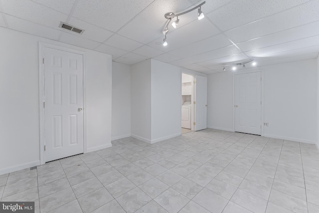 3460 Summit Ct NE Unit 3460, Washington, DC 20018 - finished basement with washer / clothes dryer, a drop ceiling, and light tile patterned floors