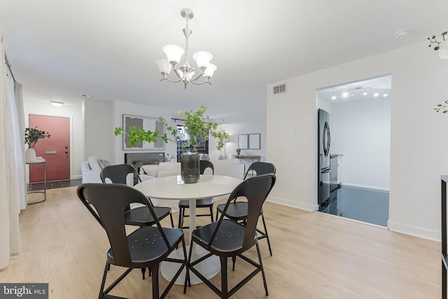 3460 Summit Ct NE Unit 3460, Washington, DC 20018 - dining area with a chandelier and light wood-type flooring