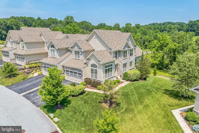3132 Butternut Ln, Chester Springs, PA 19425 - view of front facade featuring stone siding, driveway, a front yard, and a shingled roof