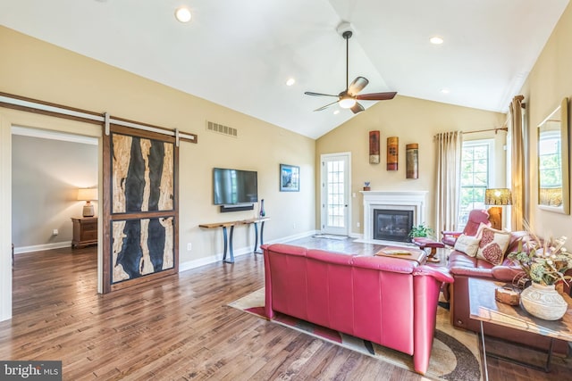 3132 Butternut Ln, Chester Springs, PA 19425 - living room with plenty of natural light, a glass covered fireplace, wood finished floors, vaulted ceiling, and a ceiling fan