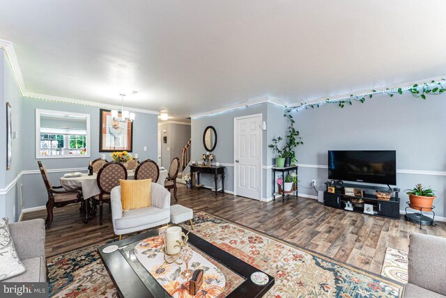 2129 Fort Donelson Ct, Dumfries, VA 22026 - living room featuring a chandelier, wood finished floors, and ornamental molding