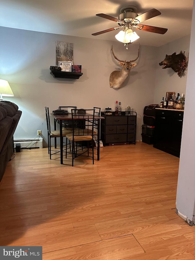 884 Main St, Pennsburg, PA 18073 - dining space with wood finished floors, ceiling fan, and a baseboard heating unit