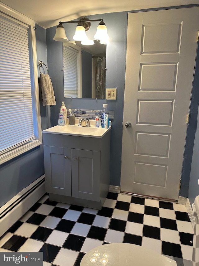 884 Main St, Pennsburg, PA 18073 - bathroom with tile patterned floors, a baseboard radiator, vanity, and a chandelier