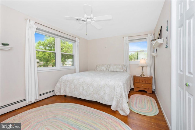 1904 Woodland Dr, Yardley, PA 19067 - bedroom with multiple windows, wood finished floors, a baseboard heating unit, and ceiling fan