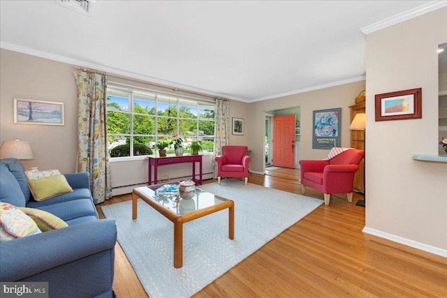 1904 Woodland Dr, Yardley, PA 19067 - living area featuring baseboard heating, wood finished floors, and ornamental molding