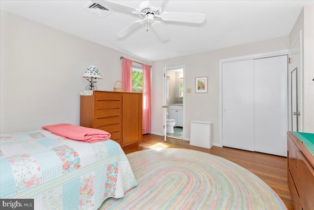 1904 Woodland Dr, Yardley, PA 19067 - bedroom with wood finished floors, a closet, connected bathroom, and a ceiling fan