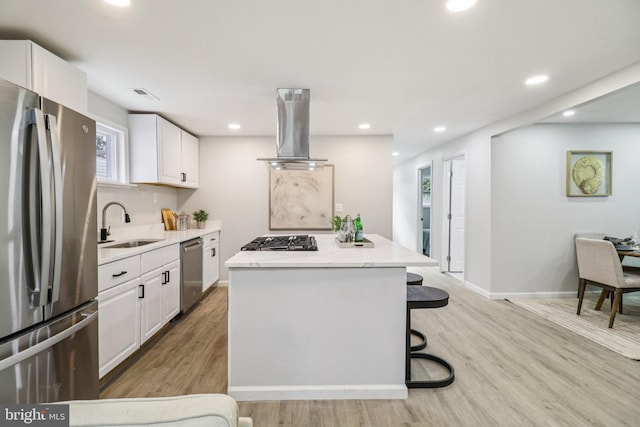 919 Mentor Ave, Capitol Heights, MD 20743 - kitchen with appliances with stainless steel finishes, extractor fan, a kitchen island, light wood-type flooring, and recessed lighting
