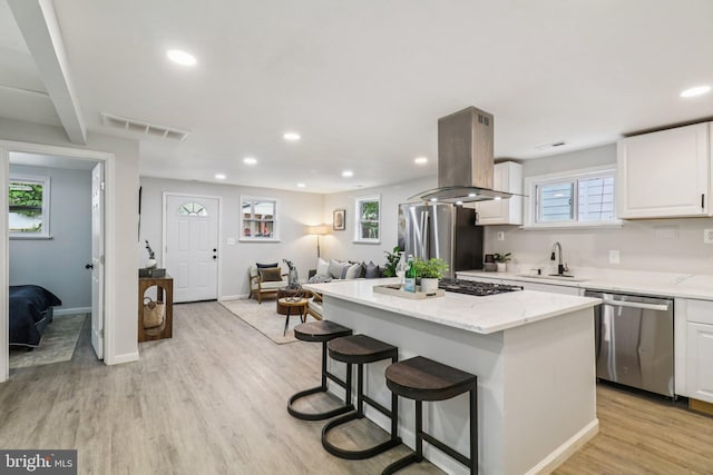 919 Mentor Ave, Capitol Heights, MD 20743 - kitchen with appliances with stainless steel finishes, island exhaust hood, recessed lighting, a kitchen island, and white cabinetry