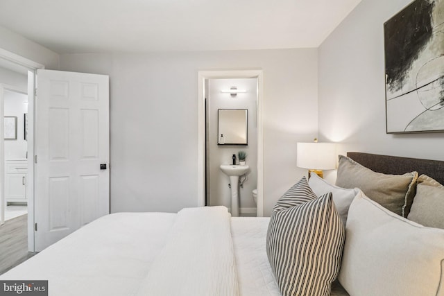 919 Mentor Ave, Capitol Heights, MD 20743 - bedroom with ensuite bathroom and wood finished floors
