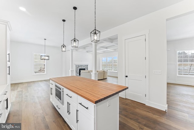 171 Ellicott Rd, Avondale, PA 19311 - kitchen with wood counters, dark wood-style floors, open floor plan, white cabinets, and decorative light fixtures