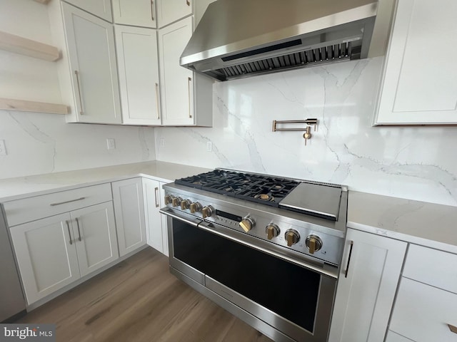 171 Ellicott Rd, Avondale, PA 19311 - kitchen featuring wall chimney exhaust hood, stainless steel range, backsplash, and wood finished floors