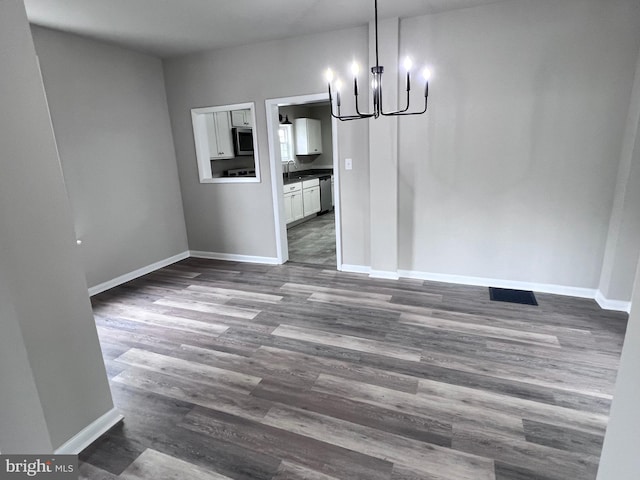 122 W N St, Waynesboro, PA 17268 - unfurnished dining area featuring a chandelier and dark wood-style floors