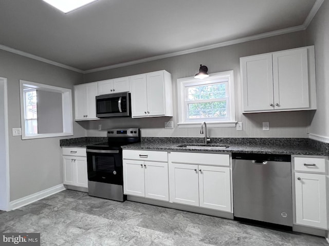 122 W N St, Waynesboro, PA 17268 - kitchen featuring appliances with stainless steel finishes, crown molding, white cabinets, and dark stone counters