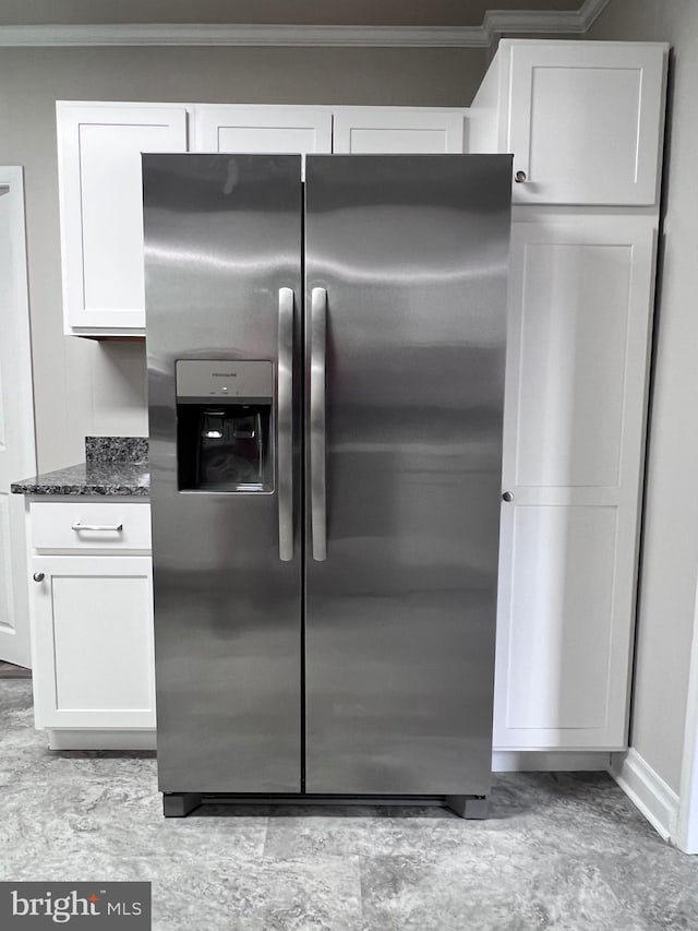 122 W N St, Waynesboro, PA 17268 - kitchen with stainless steel fridge, crown molding, white cabinetry, and dark stone counters