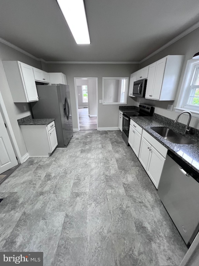 122 W N St, Waynesboro, PA 17268 - kitchen featuring stainless steel appliances, ornamental molding, dark countertops, and white cabinets