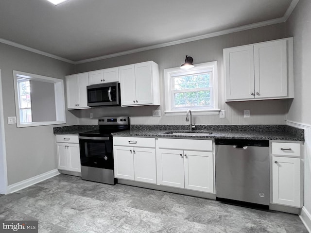 122 W N St, Waynesboro, PA 17268 - kitchen with stainless steel appliances, white cabinetry, crown molding, and dark countertops