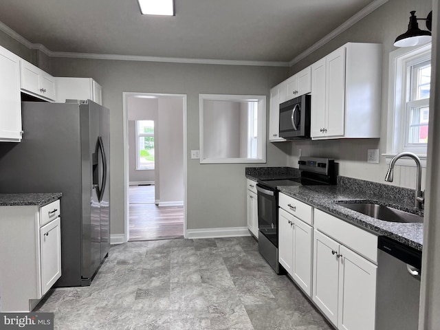 122 W N St, Waynesboro, PA 17268 - kitchen featuring appliances with stainless steel finishes, white cabinets, crown molding, dark stone countertops, and stone finish flooring