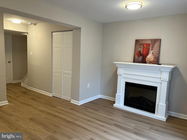 9220 Redbridge Ct, Laurel, MD 20723 - unfurnished living room with light wood finished floors and a glass covered fireplace