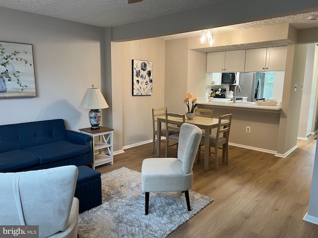 9220 Redbridge Ct, Laurel, MD 20723 - living area with wood finished floors and a textured ceiling