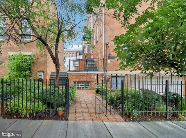 1803 T St NW Unit 11, Washington, DC 20009 - view of building exterior featuring a fenced front yard, an attached garage, and stairs