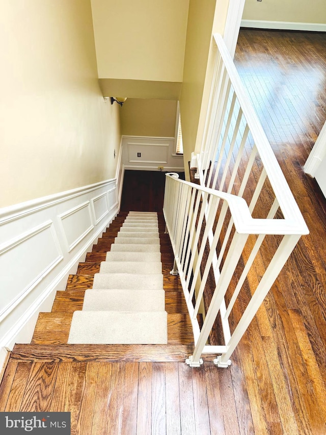 1803 T St NW Unit 11, Washington, DC 20009 - stairs featuring a decorative wall, wood-type flooring, and wainscoting